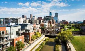 Scenic view of Denver, CO properties near the river, highlighting the importance of a boundary survey before buying or building.