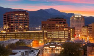 Colorado Springs cityscape at sunset, highlighting the area where an ALTA survey ensures accurate property boundaries and land details