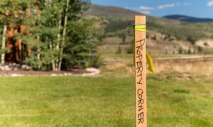 A cadastral surveyor's property corner marker, indicating the boundary line on a commercial land site.