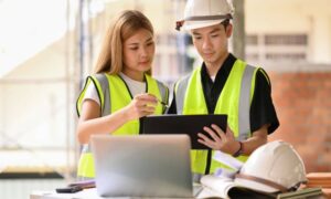 Engineers reviewing development plans during a project management discussion at a construction site