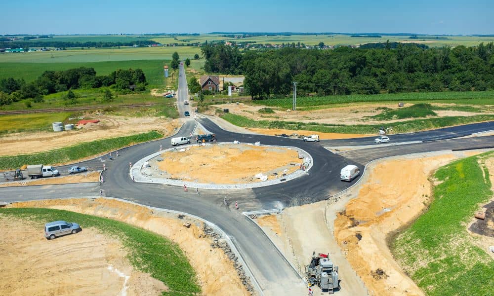 Aerial view of a newly constructed roundabout and road layout designed by a traffic engineer to improve site access and vehicle flow