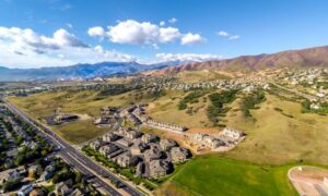 Aerial view of Colorado Springs homes beside open foothill land, a setting where property line surveys help define boundaries