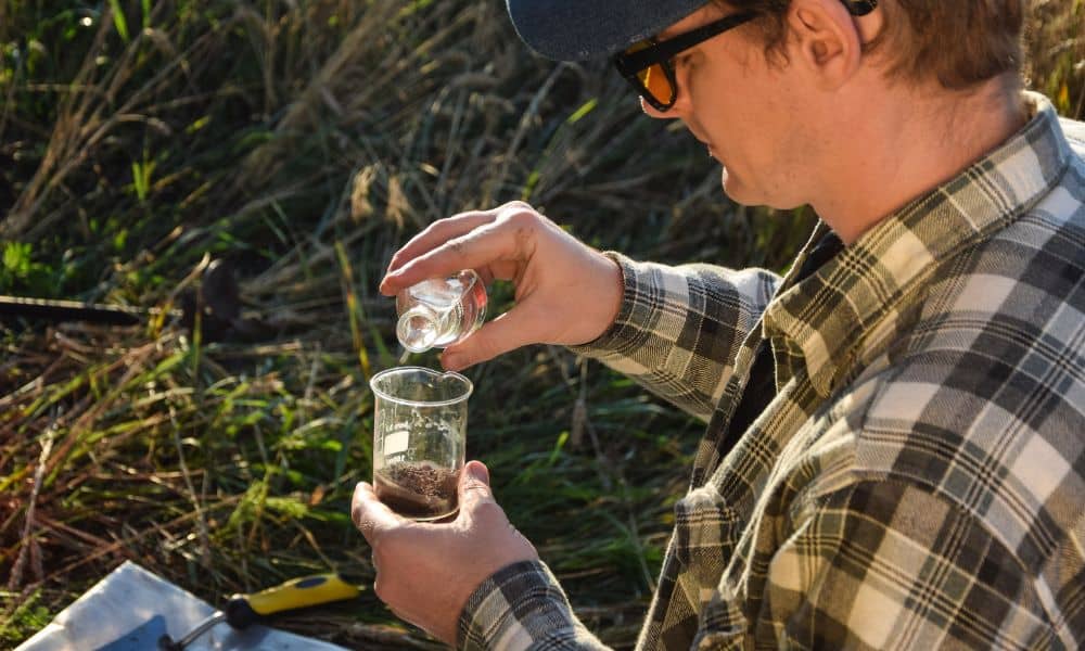 Perc test denver soil sample - ALTA SURVEY Colorado Technician performing a perc test by pouring water into a soil sample in Denver