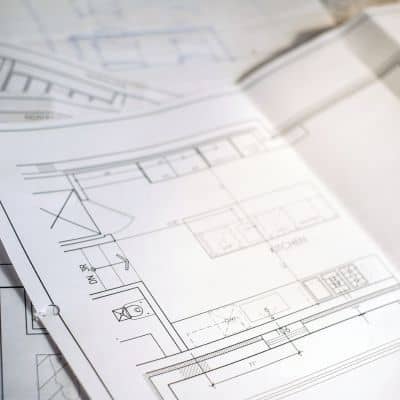 Two people reviewing a map during a boundary line survey to understand property lines, easements, and right-of-way limits