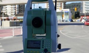 Total station set up beside a roadway for a boundary line survey to confirm right-of-way and property limits