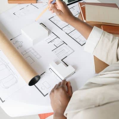 Drone land surveying data reviewed against construction plans and site coordinate grids
